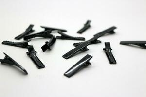 Black hair clips scattered on the floor photo