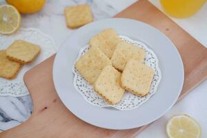 Crispy crackers and lemon juice on a white background. photo