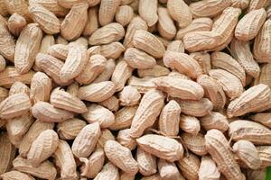 Peanuts in the shell on the wooden background. Close up. photo