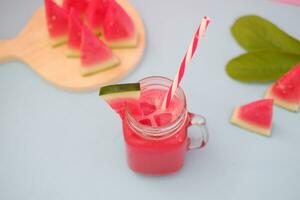 Watermelon smoothie in a glass jar with straws as a background photo