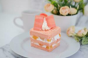 Slice of cake on white marble background. Selective focus. photo