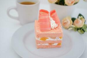 Slice of cake on white marble background. Selective focus. photo