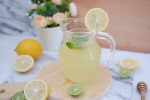 Lemonade with fresh lemon and mint leaves on a white background photo