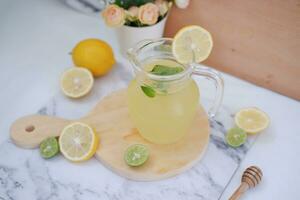 Lemonade with fresh lemon and mint leaves on a white background photo