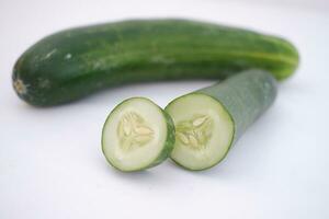 Cucumber and slices on a white background. Selective focus. photo