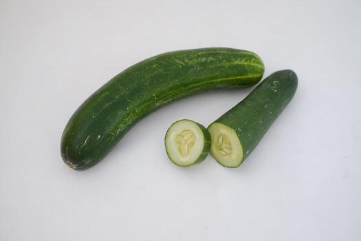 Cucumber and slices on a white background. Selective focus. photo