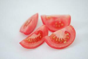 Tomatoes on a white background. Slices of tomatoes. photo