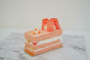 Piece of cake and cup of tea on white background, stock photo