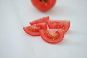 Tomatoes on a white background. Slices of tomatoes. photo