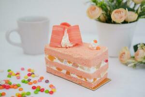 Slice of cake on white marble background. Selective focus. photo