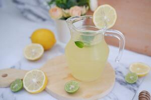 Lemonade with fresh lemon and mint leaves on a white background photo