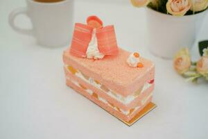 Slice of cake on white marble background. Selective focus. photo