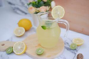 Lemonade with fresh lemon and mint leaves on a white background photo