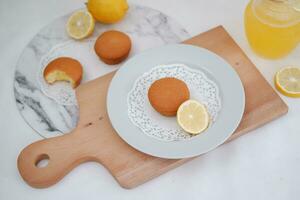 Lemon cake with lemon on wood background. Selective focus. photo