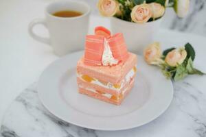 Slice of cake on white marble background. Selective focus. photo