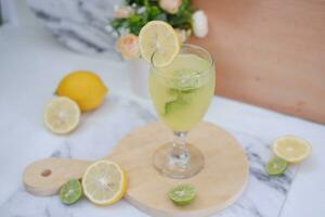 Lemonade with lime, mint and ice on a white background photo