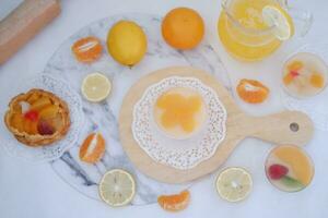 Fresh orange juice in glass and fresh citrus fruits on white background. photo