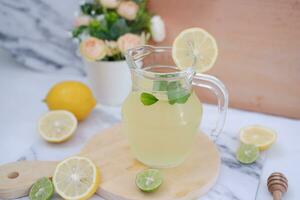 Lemonade with fresh lemon and mint leaves on a white background photo