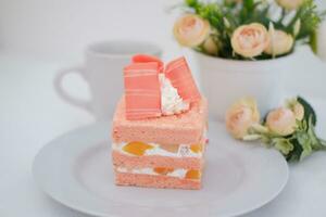 Slice of cake on white marble background. Selective focus. photo