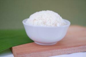 Cooked rice in a bowl on a banana leaf. Selective focus. photo