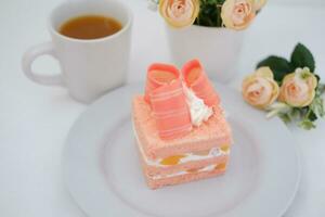 Slice of cake on white marble background. Selective focus. photo