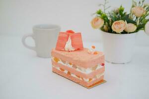 Slice of cake on white marble background. Selective focus. photo