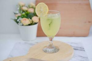 Lemonade with lime, mint and ice on a white background photo