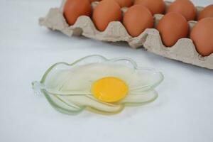 Eggs in a carton box on a white background. photo