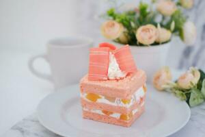 Slice of cake on white marble background. Selective focus. photo