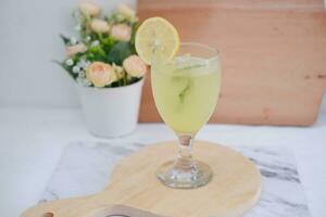 Lemonade with lime, mint and ice on a white background photo