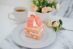 Slice of cake on white marble background. Selective focus. photo