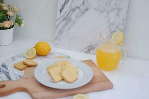 Crispy crackers and lemon juice on a white background. photo
