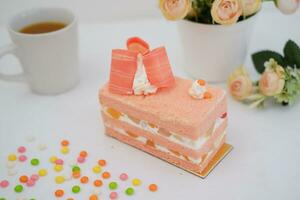 Slice of cake on white marble background. Selective focus. photo