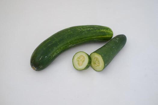 Cucumber and slices on a white background. Selective focus. photo