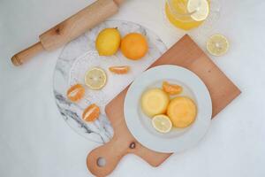 Orange jelly with fresh lemon and orange juice on a white background. photo