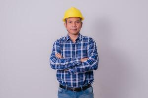 Asian engineer in striped shirt on white background photo