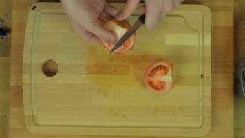 Woman Chopping Tomato at Wooden Kitchen Table video