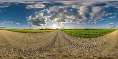 360 hdri panorama on gravel road with evening clouds on blue sky before sunset in equirectangular spherical seamless projection, use as sky replacement in drone panoramas, game development as sky dome photo