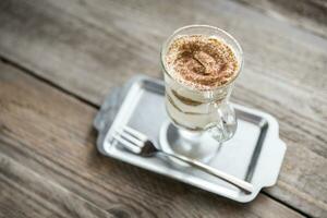 Tiramisu in the glass on the wooden background photo