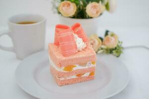 Slice of cake on white marble background. Selective focus. photo