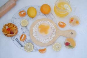 Fresh orange juice in glass and fresh citrus fruits on white background. photo