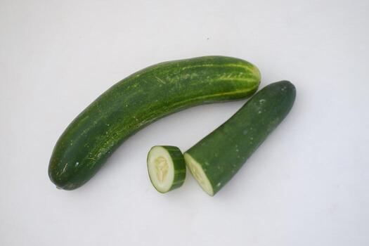 Cucumber and slices on a white background. Selective focus. photo