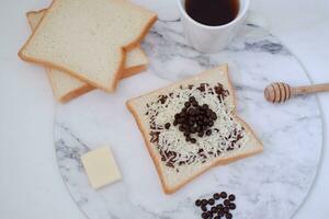 Breakfast with coffee and toast on white marble table, stock photo