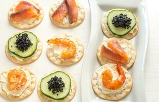 Canape with seafood on the plate photo