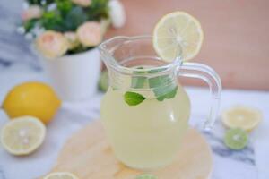 Lemonade with fresh lemon and mint leaves on a white background photo