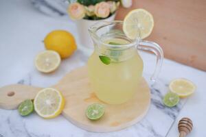 Lemonade with fresh lemon and mint leaves on a white background photo