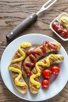 Grilled sausages with tomato and mustard sauce photo