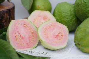 Fresh guava fruit with green leaves on white background, Thailand. photo