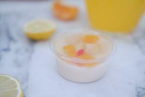 Yogurt with lemon, orange and grapefruit on white background photo
