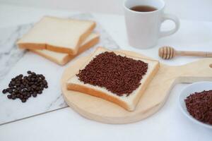 Sandwich with chocolate and coffee on a wooden board, stock photo